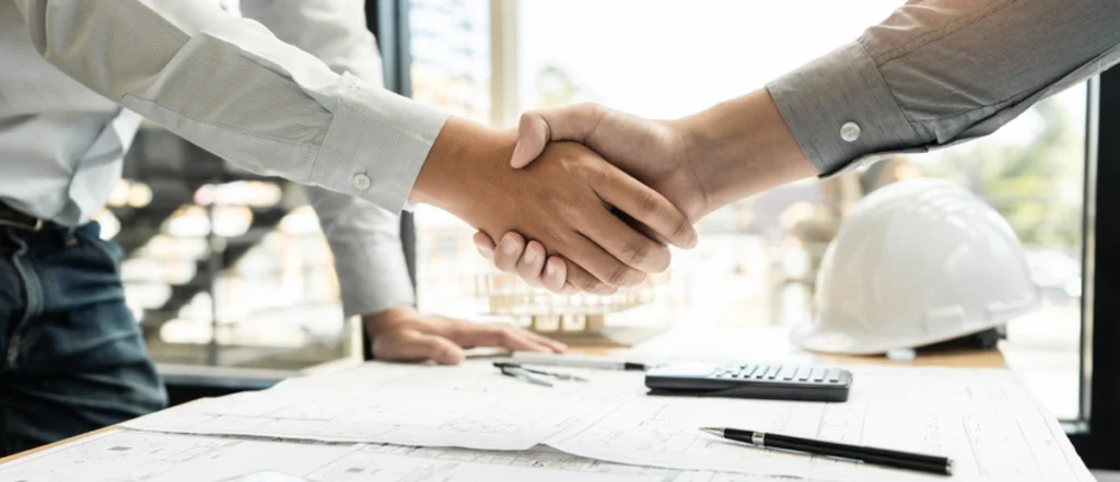 Contractor shaking hands with a revenue deal for a garage 
